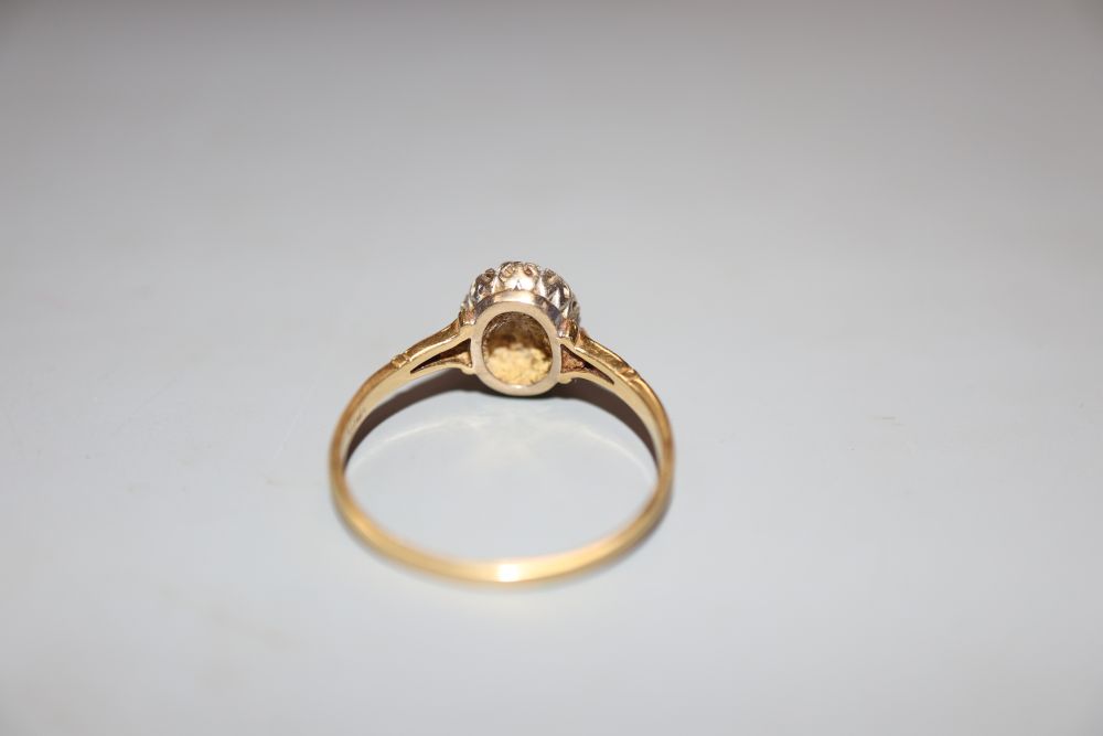 An 18ct, sapphire and diamond set oval cluster ring, size T, gross 3.2 grams.